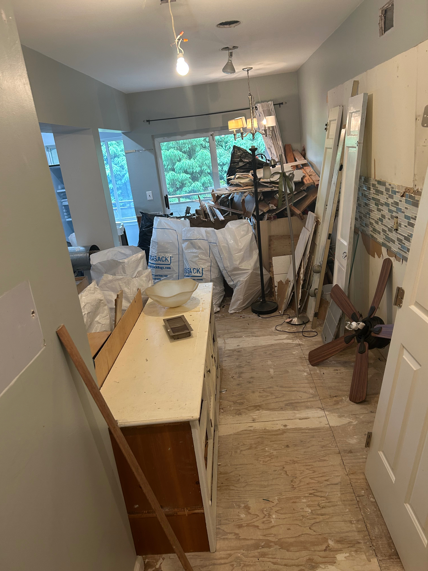 Kitchen and dining demo debris removal with open floor space restored in New Jersey — before
